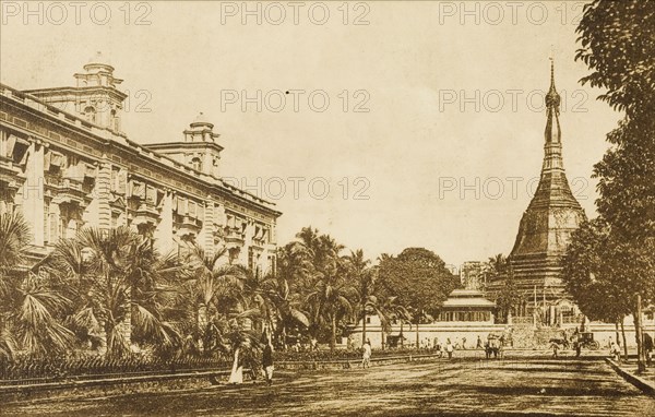 The Sule Pagoda from the south. View of the Sule Pagoda from the south. The pagoda stands at the end of a promenade lined with trees, with a large, grand building on the left. Rangoon (Yangon), Burma (Myanmar), circa 1920. Yangon, Yangon, Burma (Myanmar), South East Asia, Asia.