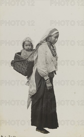 Portrait of a Nepalese woman and baby. Portrait of a Nepalese woman and baby. The women wears traditional dress including an ornate necklace, earrings and bracelets: her baby rides in a basket, securely strapped to her back and head. Nepal, circa 1922. Nepal, Southern Asia, Asia.