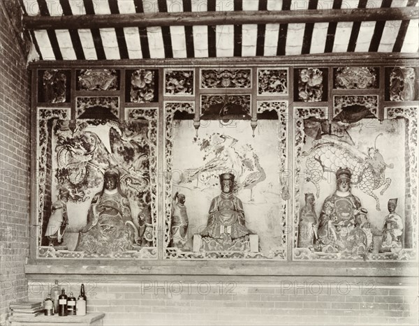 Deities inside a Chinese Joss house. Statues of Chinese deities ('Joss') line the walls inside a Joss house (Chinese temple). Santan Island, Zhejiang Province, China, circa 1905. Santan Island, Zhejiang, China, People's Republic of, Eastern Asia, Asia.