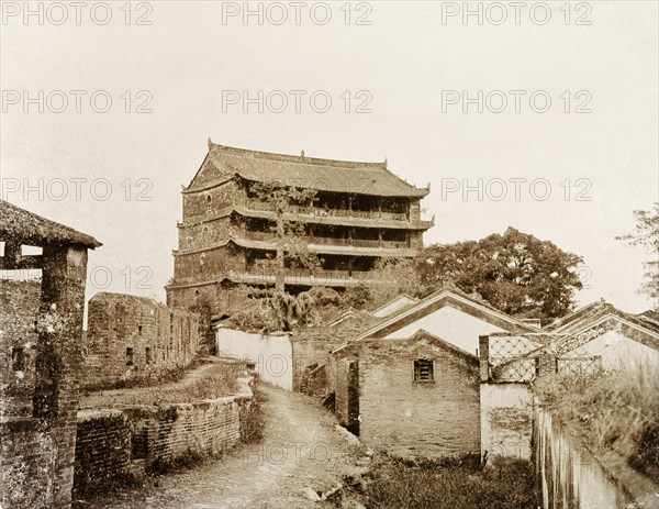 A five-storey pagoda in Canton. A five-storey pagoda stands beside the ruins of an old city wall. An original caption comments that the building was occupied by British forces in 1840, probably during the First Opium War (1839-1842). Canton, Canton Province (Guangzhou, Guangdong), China, circa 1905. Guangzhou, Guangdong, China, People's Republic of, Eastern Asia, Asia.