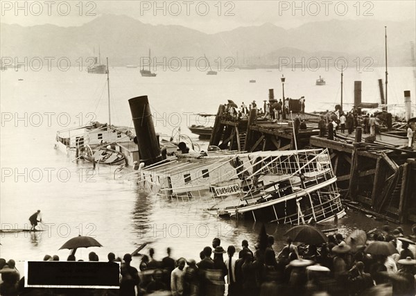 River steamer capsized by a typhoon. Wreck of the river steamer, 'San Cheong', after she was capsized in harbour by a devastating typhoon that killed an estimated 10,000 people. Hong Kong, China, circa 19 September 1906., Hong Kong, China, People's Republic of, Eastern Asia, Asia.