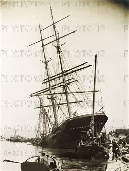 The 'Hitchcock' stricken by a typhoon. The 'Hitchcock', a large sailing ship, lies stricken on the 'praya' (waterfront promenade) at Hong Kong, in the aftermath of a devastating typhoon that killed an estimated 10,000 people. Hong Kong, China, circa 19 September 1906., Hong Kong, China, People's Republic of, Eastern Asia, Asia.