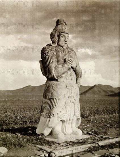 Statue of a Chinese warrior at the Ming Dynasty tombs. One of several ancient stone statues, depicting Chinese warriors in battle dress, that guide the way to the Ming Dynasty tombs. The site contains the mausoleums of 13 Emperors of the Chinese Ming Dynasty (1368-1644). Near Peking, (Beijing), China, circa 1910., Beijing, China, People's Republic of, Eastern Asia, Asia.