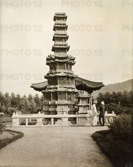 Pagoda-style monument in Seoul. Two European men chat together beneath an ornate pagoda-style monument in a public garden. Seoul, Korea (South Korea), circa 1920. Seoul, Special City, South Korea, Eastern Asia, Asia.