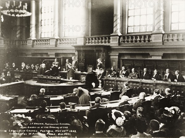 Opening of the Legislative Council in Pretoria. British dignitaries Sir Arthur Lawley, the Duke of Connaught, and General Lyttleton, swear in J.F. Brown, Postmaster-General, at the opening of the first Legislative Council of the Transvaal. The meeting took place inside the Ou Raadsaal (Old Council Chamber). Pretoria, South Africa, 20 May 1903. Pretoria, Gauteng, South Africa, Southern Africa, Africa.