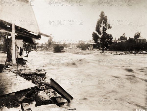 Flooding in Bloemfontein. A burst dam resulting from freak rainfall causes a flood to rampage down a street in Bloemfontein, sweeping away buildings in its path. 176 buildings and shops were destroyed by the flood, and approximately 25 people lost their lives. Bloemfontein, South Africa, 17 January 1904. Bloemfontein, Free State, South Africa, Southern Africa, Africa.