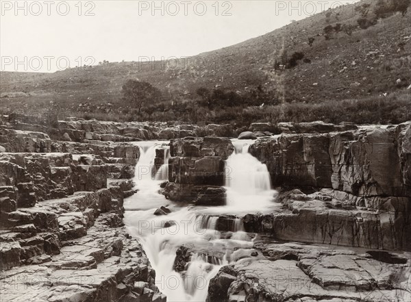 Stream on the basalt beds of the Eastern Transvaal. A stream runs over the basalt beds of the Eastern Transvaal (Mpumalanga). Transvaal (Mpumalanga), South Africa, circa 1904., Mpumalanga, South Africa, Southern Africa, Africa.