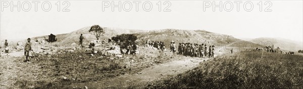 Landscape at Embabaan. A landscape at Embabaan, the capital of Swaziland. A number of Swazi people gather on a dirt road before an 'indaba' (council) with British officials. Embabaan (Mbabane), Swaziland, circa August 1904. Mbabane, Hhohho, Swaziland, Southern Africa, Africa.