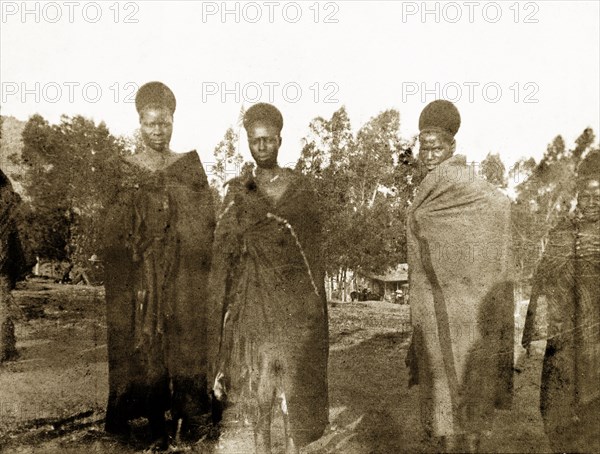 Three Swazi princesses. Three Swazi princesses pose for a photograph at a 'indaba' (council) with British officials. They wear full-length robes and their hair is worn up. Near Mbabane, Swaziland, 24 August 1904. Mbabane, Hhohho, Swaziland, Southern Africa, Africa.