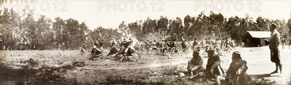 Swazi warriors perform a war dance. Swazi warriors perform a war dance for visiting British officials in the Resident Commissioner's garden. Embabaan (Mbabane), Swaziland, circa 1904. Mbabane, Hhohho, Swaziland, Southern Africa, Africa.