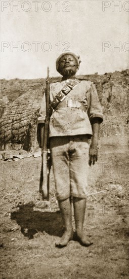Zulu policeman. Portrait of a Zulu policeman, standing to attention, part of a force recruited by the British to help control Swaziland. Embabaan (Mbabane), Swaziland, circa August 1904. Mbabane, Hhohho, Swaziland, Southern Africa, Africa.