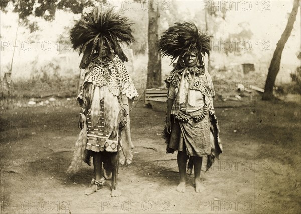 Portrait of two Swazi healers. Portrait of two Swazi healers, dressed in animal skins and jewellery with elaborate feather headdresses. Swaziland, circa 1903. Swaziland, Southern Africa, Africa.