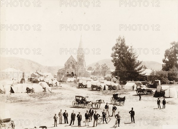 Market next to the church in Heidelberg. Tents and covered wagons wait for a market to open outside a church in Heidelberg. Heidelberg, Eastern Transvaal (Mpumalanga), South Africa, November 1905. Heidelberg, Mpumalanga, South Africa, Southern Africa, Africa.