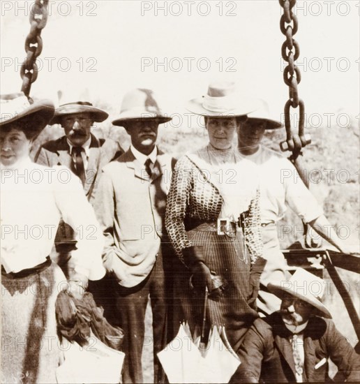 Preparing to cross the Zambezi gorge. A group of British passengers, including Lady Annie Lawley (wife of Sir Arthur Lawley) and Arthur Rhodes (brother of Cecil John Rhodes), prepare to cross the Zambezi gorge at Victoria Falls in a cage attached to a cable system. Matabeleland, Rhodesia (Matabeleland North, Zimbabwe), circa 1904., Matabeleland North, Zimbabwe, Southern Africa, Africa.