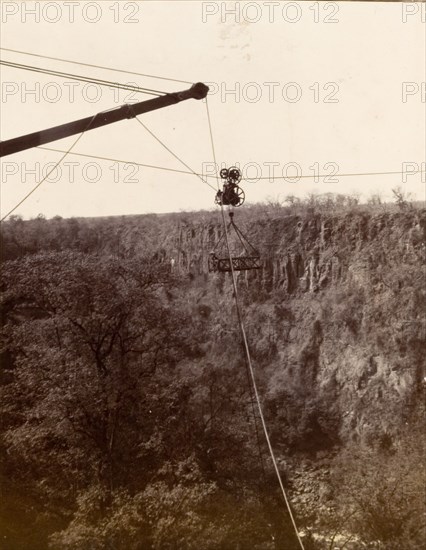 Cable system across the Zambezi gorge. A cage attached to a cable system is suspended high above the Zambezi gorge, designed to carry passengers over the river at Victoria Falls. Matabeleland, Rhodesia (Matabeleland North, Zimbabwe), circa 1904., Matabeleland North, Zimbabwe, Southern Africa, Africa.