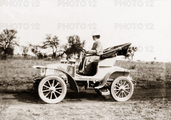 Lady Lawley in De Dion-Bouton car. Lady Annie Lawley, wife Sir Arthur Lawley, Lieutenant Governor of the Transvaal, drives her new De Dion-Bouton car along a rural road. South Africa, circa 1904. South Africa, Southern Africa, Africa.