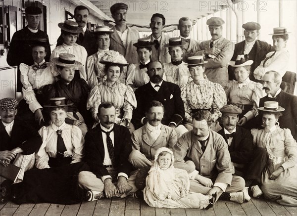 First Class passengers on SS Norman. First Class passengers of the SS Norman pose for a group portrait with Captain Maloney (centre), enroute from England to Cape Town. Atlantic Ocean, March 1897., Atlantic Ocean, Africa.