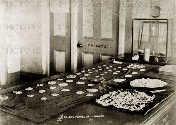 A ?60,000 parcel of diamonds'. A long table is covered with parcels of diamonds at the De Beers offices in Kimberley. According to an original caption, these jewels were worth ?60,000 at the time of this photograph. Kimberley, South Africa, circa 1896. Kimberley, North Cape, South Africa, Southern Africa, Africa.