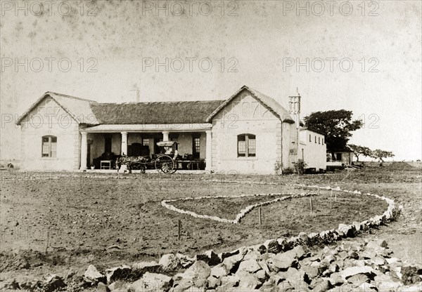 Government House, Bulawayo. View of Government House, a single-storey stone building with the makings of a garden laid out in front. Bulawayo, Rhodesia (Zimbabwe), 1897. Bulawayo, Matabeleland North, Zimbabwe, Southern Africa, Africa.