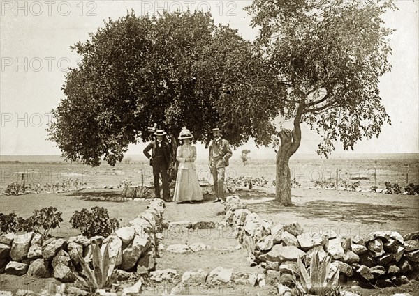 Lobengula's tree'. Captain Arthur Lawley (1860-1932) on the left, Lady Annie Lawley (1863-1944), and Earl Grey (1851-1917), pose beside a tree at the spot where the last Matabele King, Lobengula Kumalo, used to review his warriors and indunas (chiefs). Rhodesia (Zimbabwe), 1897.