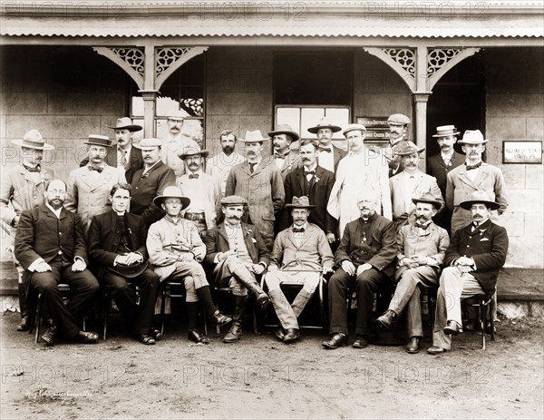 Bulawayo railway celebration committee. Formal portrait of members of the Railway Committee, taken to commemorate the arrival of the railway at Bulawayo. At the centre of the group are Captain Arthur Lawley (1860-1932), Administrator of Matabeleland, and William Milton (1854-1930), Administrator of Mashonaland. Bulawayo, Rhodesia (Zimbabwe), circa October 1897. Bulawayo, Matabeleland North, Zimbabwe, Southern Africa, Africa.