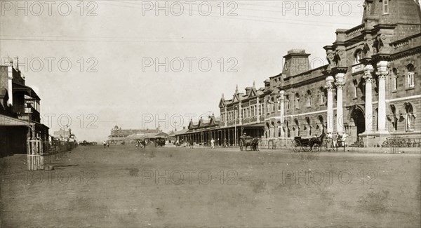 Post Office on urban street in Mashonaland. View of a Post Office located along a wide, urban street in Mashonaland. The road is wide to allow teams of oxen pulling carriages and wagons to turn round. Mashonaland, Rhodesia (Mashonaland East, Zimbabwe), circa 1896., Mashonaland East, Zimbabwe, Southern Africa, Africa.