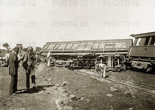 Derailed carriage on the Bulawayo line. A derailed railway carriage lies stricken on the Mafeking to Bulawayo railway track, shortly before the line's official opening ceremony on 4 November 1897. Bulawayo, Rhodesia (Zimbabwe), October 1897. Zimbabwe, Southern Africa, Africa.