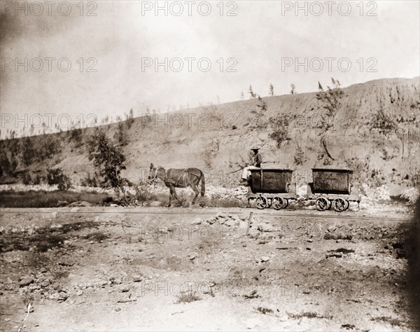 Horse pulling mine carts at Kimberley. A horse pulls two mine carts along a small gauge rail track at the Kimberley diamond mine. Kimberley, South Africa, circa 1896. Kimberley, North Cape, South Africa, Southern Africa, Africa.