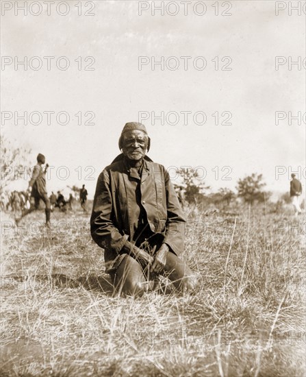 Portrait of a Matabele man. Portrait of an elderly Matabele (Ndebele) man, kneeling on the grass at an indaba (council) hosted by Cecil Rhodes at Sauerdale farm. Rhodes bought the farm after negotiating an end to the Matabele rebellion. Near Bulawayo, Rhodesia (Zimbabwe), 5 July 1897., Matabeleland North, Zimbabwe, Southern Africa, Africa.
