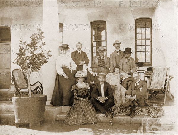 Guests at Government House in Bulawayo. A group of British administrators and their wives pose for an informal portrait on the veranda of Bulawayo's Government House. Bulawayo, Rhodesia (Zimbabwe), circa 1897. Bulawayo, Matabeleland North, Zimbabwe, Southern Africa, Africa.