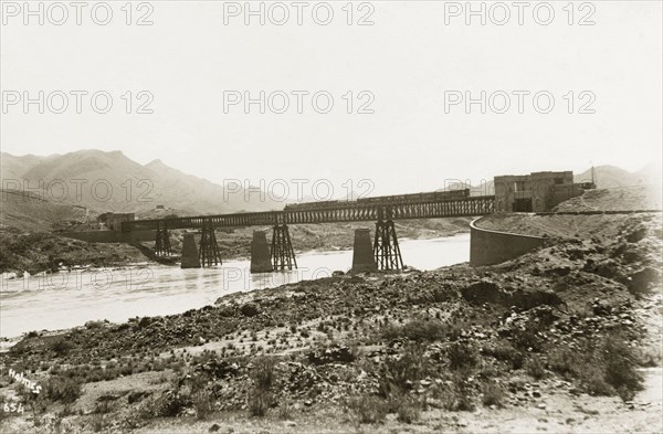 Bridge over the Indus River at Attock. A train travels on a railway bridge across the Indus River. Attock, Punjab, India (Pakistan), circa 1925. Attock, Punjab, Pakistan, Southern Asia, Asia.