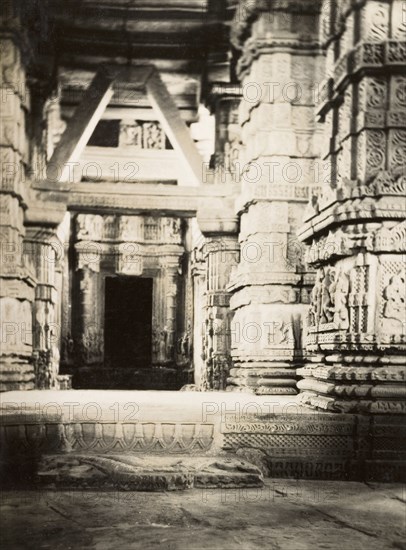 Interior of Sas-bahu Temple at Gwalior. Interior view of the larger Sas-bahu Temple, located within the Gwalior Fort complex. Completed in 1093AD, the pillars, lintels and steps are decorated with elaborately detailed sculptures and carvings of figures, flowers and patterns. Gwalior, Central Provinces and Berar (Madhya Pradesh), India, circa 1927. Gwalior, Madhya Pradesh, India, Southern Asia, Asia.