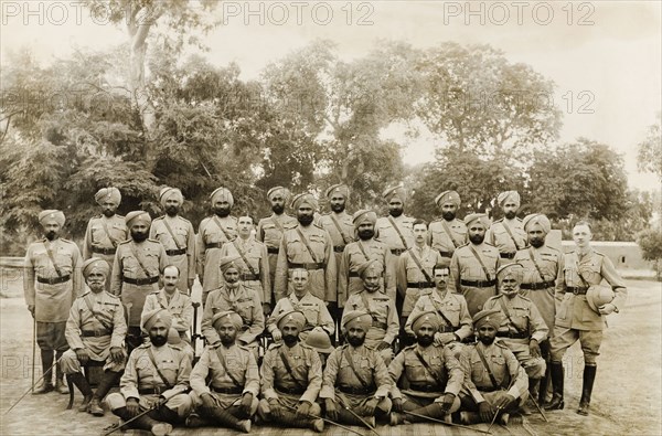 14th Sikh Regiment of the Indian Army. Group portrait of the Sikh officers and British captains of the 14th Sikh Regiment of the Indian Army. Multan, Punjab, India (Pakistan), 1919. Multan, Punjab, Pakistan, Southern Asia, Asia.