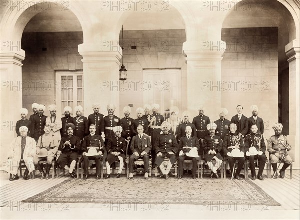 Portrait of Indian and British dignitaries. Uniformed Indian and British dignitaries line up for a group portrait beneath the pillared arches of Kapurthala Palace. Kapurthala, Punjab, India, 13 February 1920. Kapurthala, Punjab, India, Southern Asia, Asia.