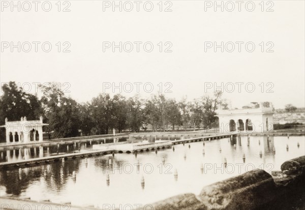 The Shalimar Gardens in Lahore. View across a rectangular marble pool and Mughal-style summer pavillions at Shalimar Gardens in Lahore. Lahore, Punjab, India (Pakistan), 1920. Lahore, Punjab, Pakistan, Southern Asia, Asia.