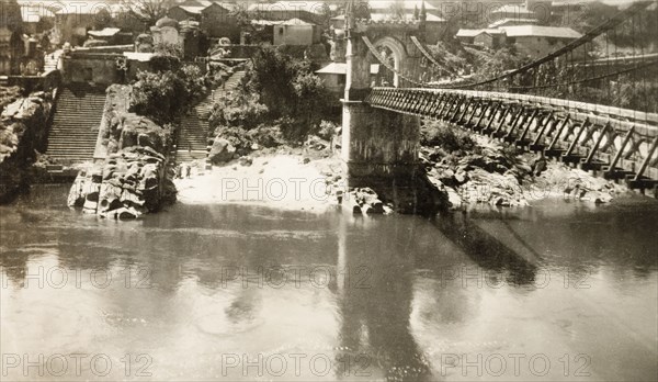Victoria Bridge in Mandi, India. View of Victoria Bridge over the Beas River at Mandi. The suspension bridge was built by Raja Bijai Sen and the colonial British government in 1877. Mandi, Simla Hill States (Himachal Pradesh), India, 1920. Mandi, Himachal Pradesh, India, Southern Asia, Asia.