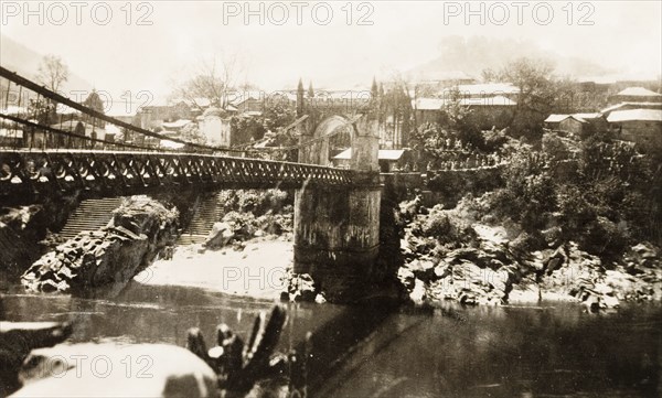 Victoria Bridge in Mandi, India. View of Victoria Bridge over the Beas River at Mandi. The suspension bridge was built by Raja Bijai Sen and the colonial British government in 1877. Mandi, Simla Hill States (Himachal Pradesh), India, 1920. Mandi, Himachal Pradesh, India, Southern Asia, Asia.