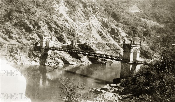 Victoria Bridge in Mandi, India. View of Victoria Bridge over the Beas River at Mandi. The suspension bridge was built by Raja Bijai Sen and the colonial British government in 1877. Mandi, Simla Hill States (Himachal Pradesh), India, 1920. Mandi, Himachal Pradesh, India, Southern Asia, Asia.