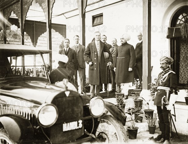 Sir Edward Maclagan and the Raja of Suket. Sir Edward Maclagan, Lieutenant Governor of the Punjab (centre), stands on a veranda in the company of several British officials and the Raja of Suket. Suket, Rajputana (Rajasthan), India, circa 28 March 1920. Suket, Rajasthan, India, Southern Asia, Asia.