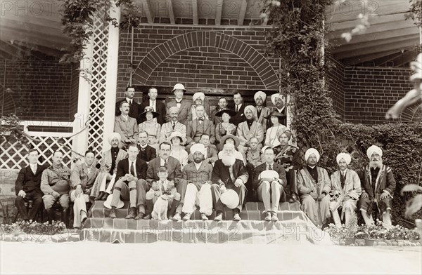 European and Indian officials at Chamba. A group of European and Indian officials pose for a group portrait on the steps of a colonial style building. Amongst the group are Sir Edward Maclagan, Lieutenant Governor of the Punjab, and the Raja of Chamba. Chamba, Simla Hill States (Himachal Pradesh), India, 1920. Chamba, Himachal Pradesh, India, Southern Asia, Asia.