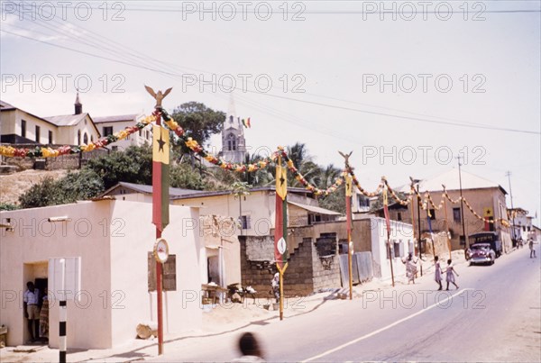 First anniversary of Ghanaian independence. A street in Cape Coast is decorated with flags and garlands to mark the first anniversary of Ghanaian independence. Cape Coast, Ghana, circa March 1958. Cape Coast, Central (Ghana), Ghana, Western Africa, Africa.