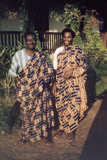 Men wearing kente cloth. Portrait of two Ghanaian men, Mr Amoako and Mr Ako, wearing traditional kente cloth. Aburi, Ghana, circa 1960. Aburi, East (Ghana), Ghana, Western Africa, Africa.