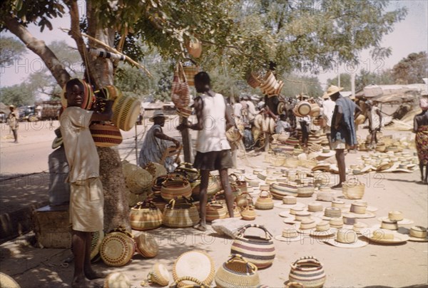Baskets at Bolgatanga market. Shoppers browse a range of baskets and woven hats at Bolgatanga market in Bolgatanga. Bolgatanga, Ghana, circa 1961. Bolgatanga, Upper East, Ghana, Western Africa, Africa.