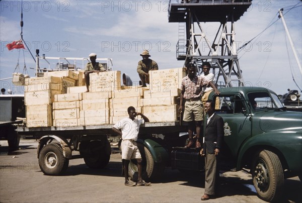 School books arrive at Takoradi. Crates full of school library books arrive on the back of an open truck at Takoradi. Takoradi, Ghana, circa 1958. Takoradi, West (Ghana), Ghana, Western Africa, Africa.