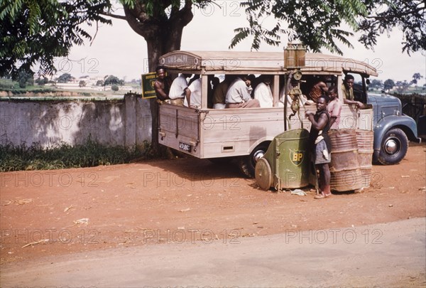 Roadside filling station. A petrol attendant fills a van from a British Petroleum (BP) pump at a roadside filling station. Kumasi, Ghana, circa 1960. Kumasi, Ashanti, Ghana, Western Africa, Africa.