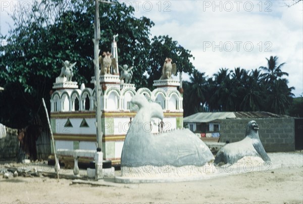 Shrine of Asafo Number Two Company. The 'posuban' (military shrine) of Asafo Number Two Company at Lowtown. This shrine was built in 1921, and the sculpture added by Kwamina Amoako in the 1950s. Saltpond, Ghana, April 1960. Saltpond, West (Ghana), Ghana, Western Africa, Africa.