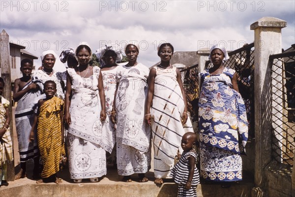 Celebrating the third anniversary of Ghanaian independence. A group of traditionally dressed Ghanaian women pose for a portrait during celebrations to commemorate the third anniversary of Ghanaian independence. Two of the women wear commemorative cloth depicting Ghana's first President, Kwama Nkrumah (1909-1972). Saltpond, Ghana, circa 1960. Saltpond, West (Ghana), Ghana, Western Africa, Africa.
