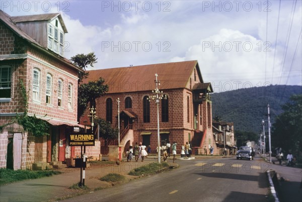 A Christian church in Freetown. View of a Christian church in Freetown, situated on a street lined with colonial-style buildings. Freetown, Sierra Leone, circa 1960. Freetown, West (Sierra Leone), Sierra Leone, Western Africa, Africa.