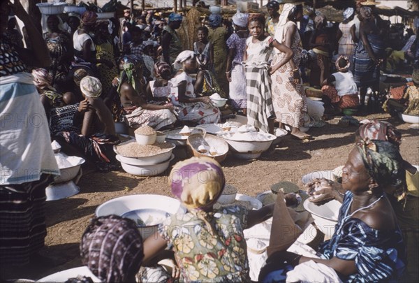 Market in Tamale, Ghana. Women sell rice and other foodstuffs at an outdoor market in Tamale. Tamale, Ghana, circa 1961. Tamale, North (Ghana), Ghana, Western Africa, Africa.