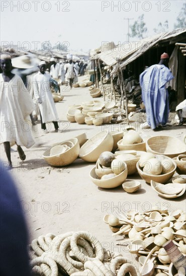 Gourd merchants, Kano. Traders sell a variety of gourd containers from stalls at a busy marketplace. Kano, Nigeria, February 1964. Kano, Kano, Nigeria, Western Africa, Africa.